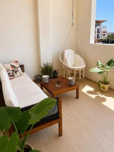 a room with a swing and a chair in it at Nàlua Sardinia Experience in Quartu SantʼElena