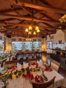 a dining room with a long table and chairs at Olvios Hotel in Goura