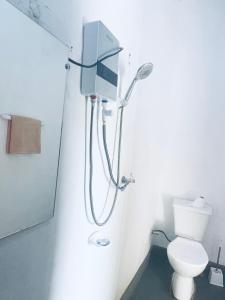 a bathroom with a shower and a toilet at Akagera Able Lodge in Akagera