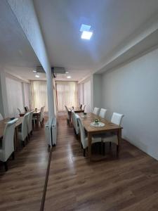 a dining room with a table and chairs at Hostel 8 in Prishtinë