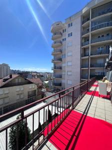 a balcony with a red carpet on a building at Hostel 8 in Prishtinë