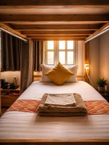 a large bed in a room with a window at Happy Bear Hostel Phu Quoc in Phú Quốc +46 photos