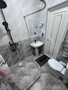 a bathroom with a toilet and a sink at Velora Hostel in Khiva +42 photos