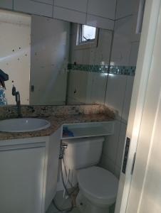 a small bathroom with a toilet and a sink at Casa ampla vila nova de colares in Serra +24 photos