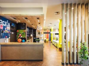 a lobby of a store with yellow chairs at Ibis Budget Sevilla Aeropuerto in Seville