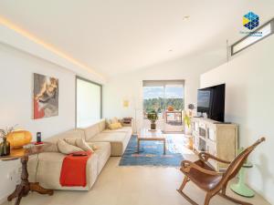 a living room with a couch and a tv at Villa Cata in Esporles