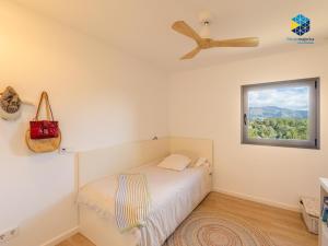 a bedroom with a bed and a ceiling fan at Villa Cata in Esporles +27 photos