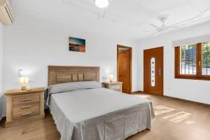 a bedroom with a large bed and a window at Villa Casa Para Ti in El Tosalet