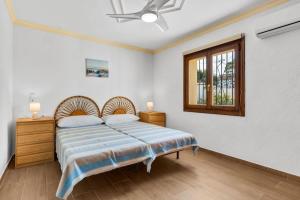a bedroom with a bed and a window at Villa Casa Para Ti in El Tosalet +31 photos