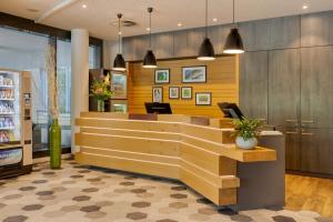 a lobby of a store with a reception desk at Citadines Arnulfpark Munich in Munich