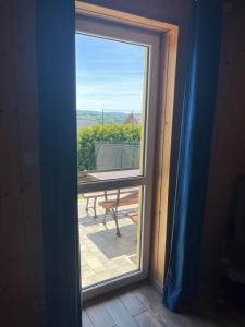 a window with a view of a picnic table at Domki pod Beskidem in Jaworzynka +24 photos