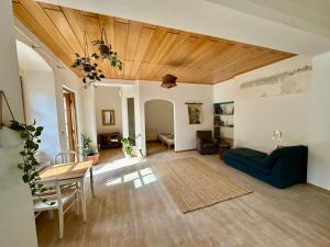 a living room with a table and a blue couch at Danube Atelier - The Garden in Rossatz