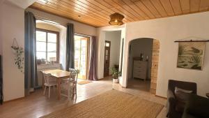 a living room with a table and a dining room at Danube Atelier - The Garden in Rossatz +17 photos
