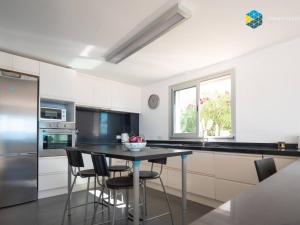 a kitchen with a table and some chairs in it at Villa Sa Troneta in Cala Pi
