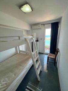 a bedroom with two bunk beds and a chair at Oceanview Vega in Sisi