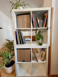a white book shelf filled with books at Danube Atelier - The Studio in Rossatz