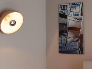 a picture of a boat on a wall with a lightswitch at ibis Styles Marseille Centre Prado Place Castellane in Marseille