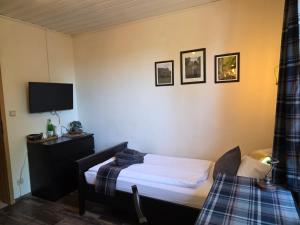 a bedroom with a bed and a tv on the wall at Locvillare in Wadern