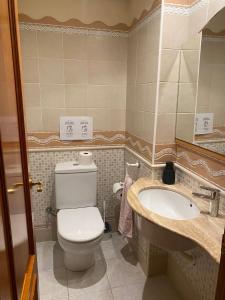 a bathroom with a toilet and a sink at Ca La Solé in Vinarós +6 photos