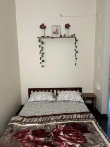 a bedroom with a bed with flowers on the wall at The Heritage Homes in Mysore