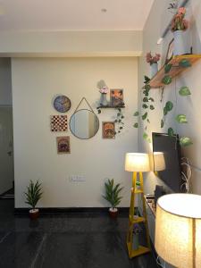 a room with plants and a mirror on the wall at The Heritage Homes in Mysore