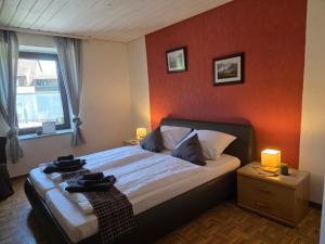 a bedroom with a bed with a red wall at Locvillare in Wadern