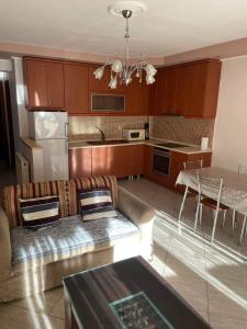 a living room with a couch and a kitchen at mema apartment in Nea Peramos +9 photos