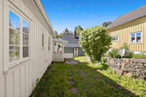 a house with a yard next to a building at Hagehuset in Kragerø