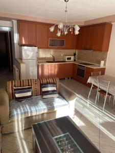 a living room with a couch and a kitchen at mema apartment in Nea Peramos