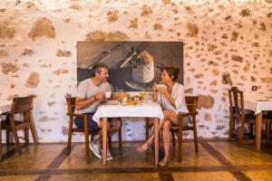 a man and woman sitting at a table in a restaurant at Hotel Boutique Rosario Martin in Puerto del Rosario