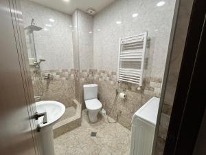 a bathroom with a toilet and a sink at Dadiani Apartment in Tbilisi City