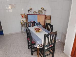 a table with chairs and a bowl of food on it at Rustic Chalet With Easy Golf Beach Access Oliva Nova in Oliva