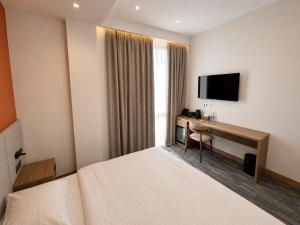 a hotel room with a desk and a television at Metropol Hotel Bishkek in Bishkek