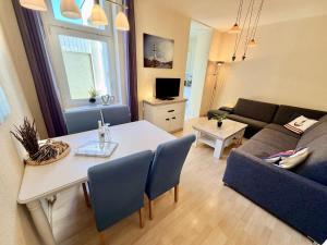 a living room with a table and a couch at WarneSonne in Warnemünde