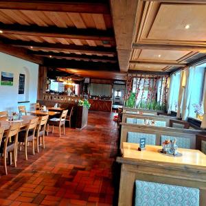 a dining room with tables and chairs in a restaurant at Hotel Restaurant Ampertal in Haag an der Amper