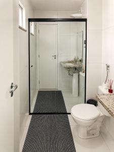 a white bathroom with a shower and a toilet at Ap Go travel in São Luís +12 photos