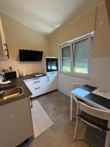 a small kitchen with a sink and a table at NB14-1 Living in Weingarten (Karlsruhe) +10 photos