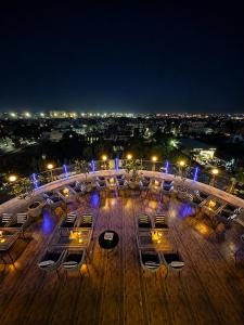 a view of a deck with tables and chairs at night at The Theme, Jaipur in Jaipur