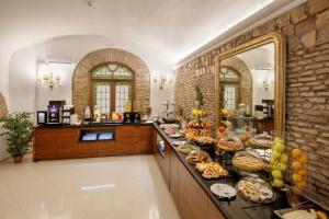 a kitchen with a buffet of food on a counter at Hotel Della Torre Argentina in Rome
