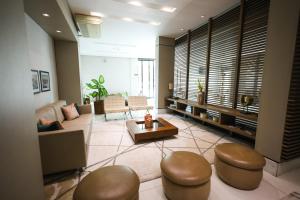 a living room with a couch and a table at Class Hotel Pouso Alegre in Pouso Alegre