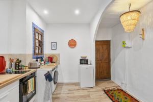 a kitchen with a sink and a refrigerator at Appartement Provençal in Cotignac