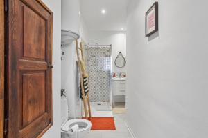 a bathroom with a toilet and a door at Appartement Provençal in Cotignac +15 photos