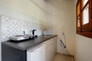 a kitchen with a sink and a counter top at Stay Easy Sidari Apartments in Sidari +26 photos