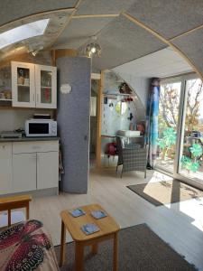 a kitchen and a living room with a table at Butterfly PODika in Lerwick