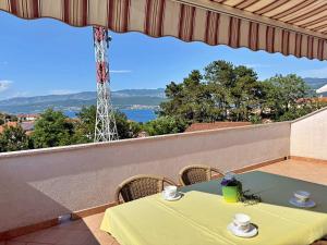 a table with two cups on a balcony with a view at Apartments Dragica in Šilo