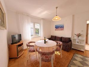 a living room with a table and a couch at Apartments Dragica in Šilo