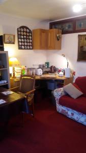 a room with a kitchen with a desk and a couch at Orton Waterville Residence in Peterborough