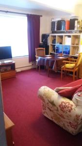 a living room with a couch and a table at Orton Waterville Residence in Peterborough