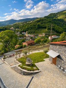 a stone building with a garden in the middle of a city at Agriturismo Terra Madre in Rapallo