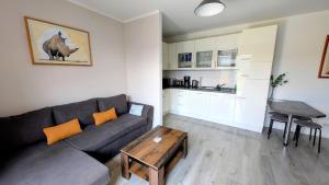 a living room with a couch and a table at Ferienwohnung in Birkenwerder mit Balkon in Birkenwerder